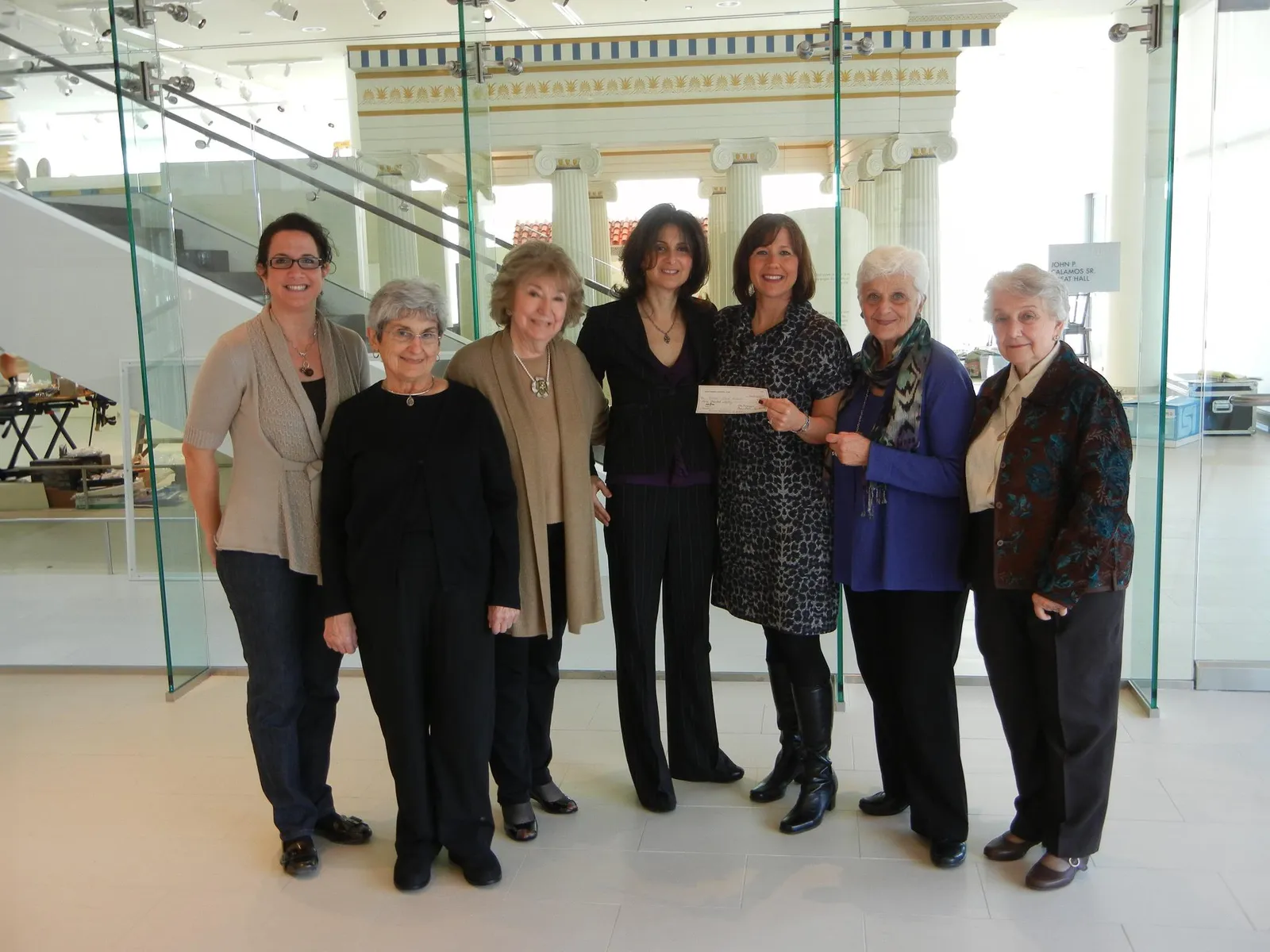 Members of the Greek Women's University Club holding a cheque