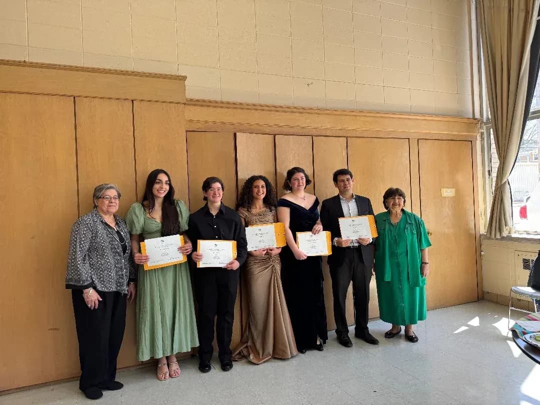 Winners holding their certificates with club officers after the 2025 competition